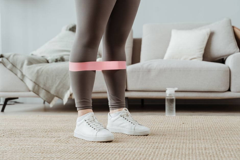 Person doing resistance band exercises at home
