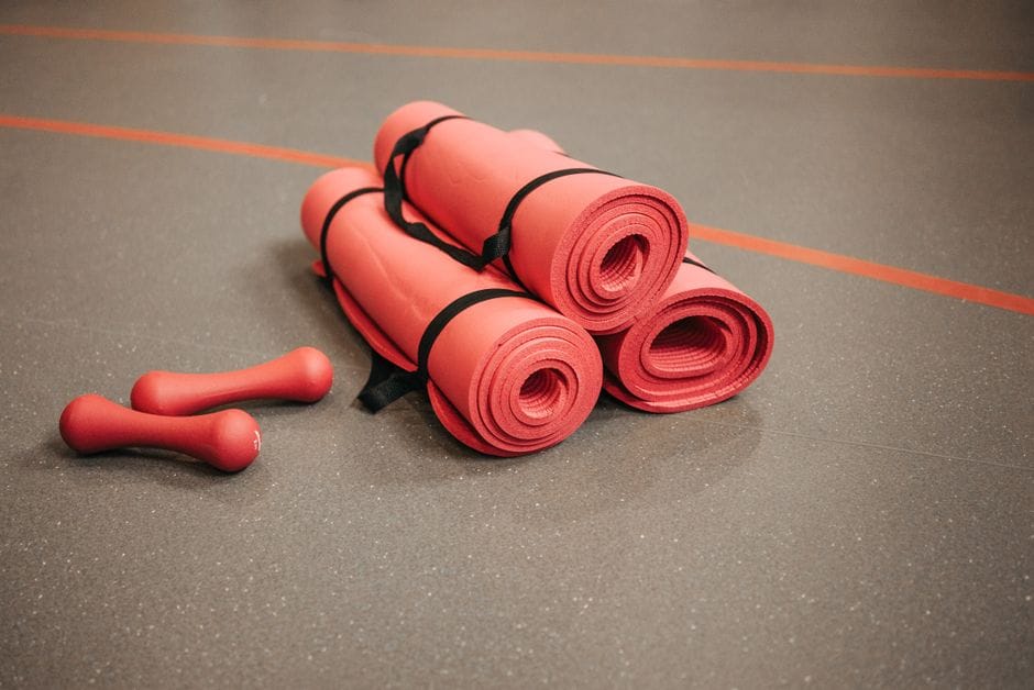 dumbbells and a mat set up for a home strength workout