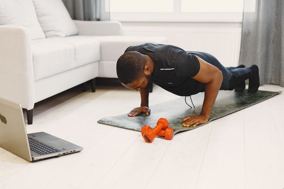 man performing bodyweight push-up during home workout
