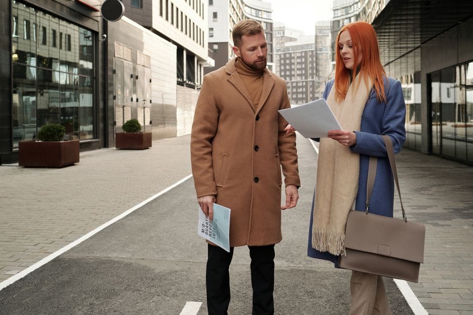 Two coworkers taking a walking meeting outside