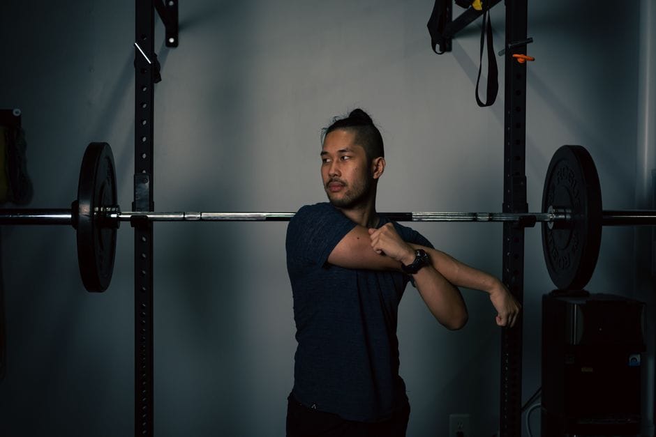 Person hinged forward performing a barbell bent-over row with a flat back