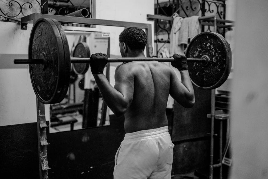 Person performing a barbell back squat with proper depth and form
