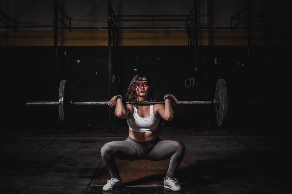 Person at the bottom of a front squat with elbows lifted high and torso upright