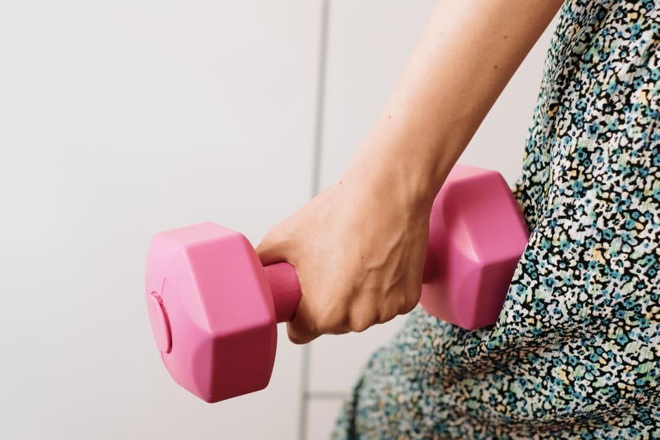 Close-up of hands gripping dumbbells in neutral hammer curl position