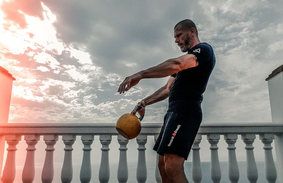 Person performing a kettlebell swing with a flat back and hip hinge