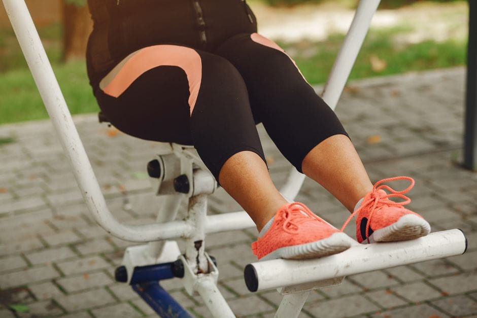 Close-up of feet positioned shoulder-width apart on a leg press platform