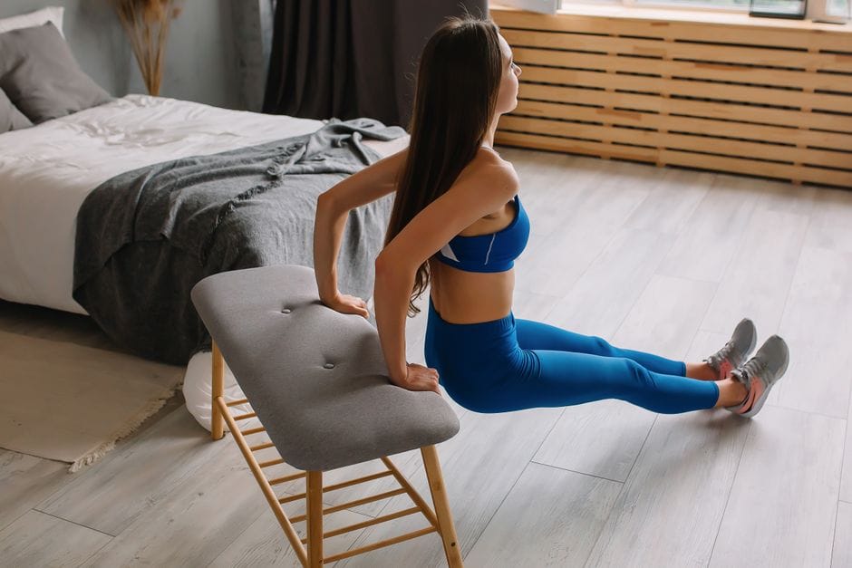 Person performing a bench tricep dip with straight arms and controlled form